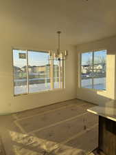 Unfurnished dining area with a chandelier