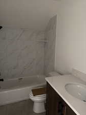 Bathroom featuring vanity, washtub / shower combination, and tile patterned flooring