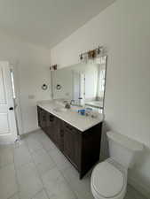 Bathroom with vanity and light tile patterned flooring