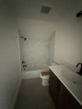Bathroom with vanity and shower / washtub combination