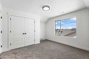 Unfurnished bedroom featuring a closet and carpet flooring