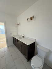 Half bathroom featuring vanity and toilet