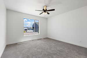 Empty room with carpet and ceiling fan