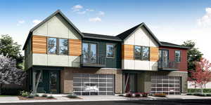 Contemporary house featuring stucco siding, a balcony, and an attached garage