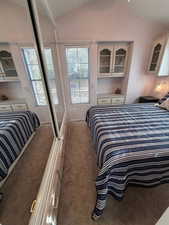 Carpeted bedroom with vaulted ceiling