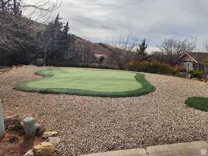 View of home's community with an area to practice putting and a mountain view