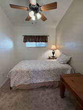 Carpeted bedroom featuring ceiling fan