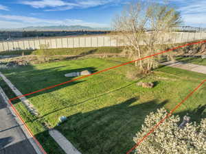 Aerial overview of property's location featuring property parcel outlined and a mountain backdrop
