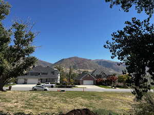 View of grassy yard with a mountain view and a residential view