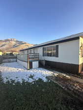 View of home's exterior featuring a deck with mountain view and a fenced backyard