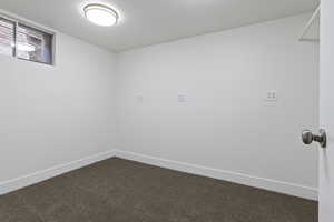 Empty room with carpet floors and a textured ceiling