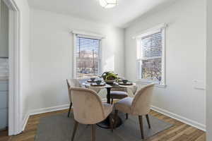 Dining room featuring baseboards and wood-type flooring