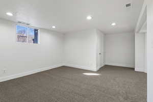 Below grade area featuring carpet floors and recessed lighting