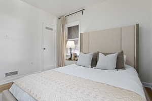 Bedroom featuring baseboards and wood finished floors