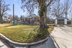 View of front of house featuring a fenced front yard, a gate, and brick siding