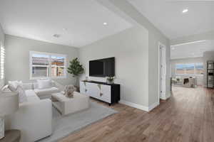 Living room featuring recessed lighting and light wood-style flooring