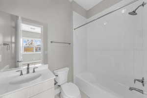 Bathroom with vanity and bathing tub / shower combination