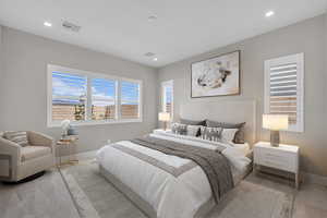 Bedroom with baseboards and light carpet