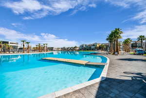 Community pool featuring a patio and a residential view