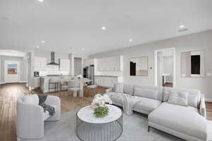 Living area featuring light wood-type flooring and recessed lighting