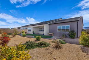 Rear view of property with a patio area, a fenced backyard, and stucco siding