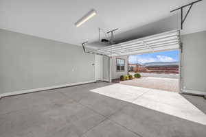 Garage with a mountain view and baseboards