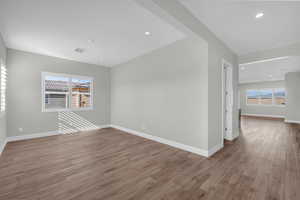 Empty room featuring recessed lighting, light wood-type flooring, and healthy amount of natural light