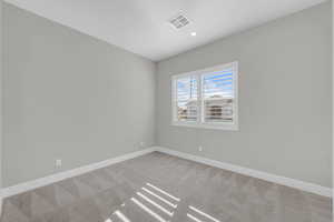 Unfurnished room with light colored carpet and recessed lighting