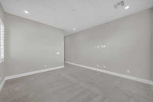 Unfurnished room with light carpet and recessed lighting