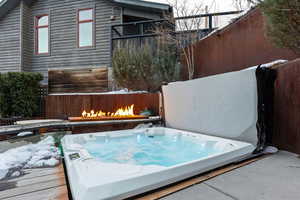 Exterior space featuring a covered hot tub