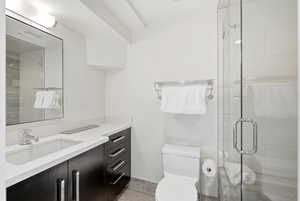 Bathroom featuring a stall shower and vanity