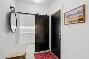 Bathroom with light tile patterned flooring and vanity