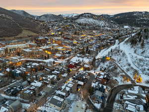 Snowy aerial view with a mountain view and a residential view