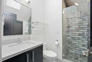Bathroom featuring a shower stall and vanity