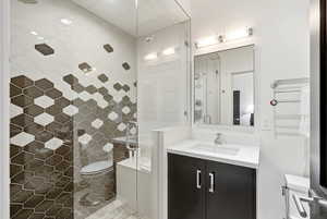 Full bathroom featuring a stall shower and vanity