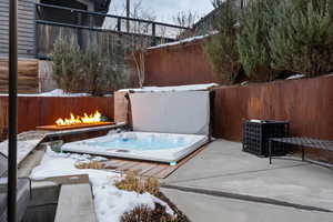 Fenced backyard with a patio area and an outdoor fire pit