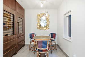Dining room with baseboards and wine cooler
