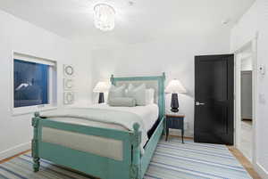 Bedroom featuring wallpapered walls and light wood-style flooring