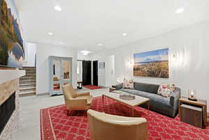 Living area featuring a fireplace, french doors, recessed lighting, and a barn door