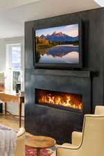 Detailed view of a fireplace and wood finished floors