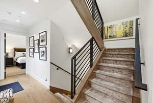 Stairs featuring wood-type flooring and recessed lighting