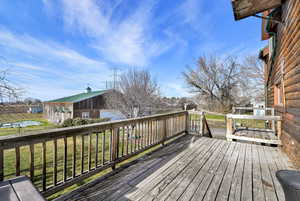 Deck featuring an outdoor structure and a yard