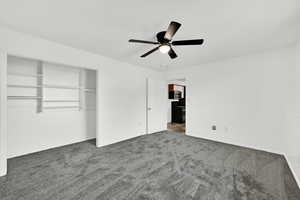 Unfurnished bedroom with carpet floors, a ceiling fan, and a closet