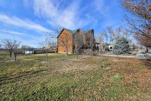 View of property exterior featuring a yard
