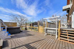 Wooden deck featuring a hot tub