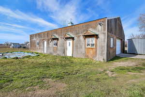 View of outbuilding featuring a garage and driveway