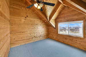 Bonus room featuring wooden walls, carpet flooring, and wooden ceiling