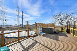 Wooden terrace featuring a hot tub