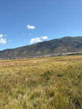 View of mountain backdrop featuring rural landscape