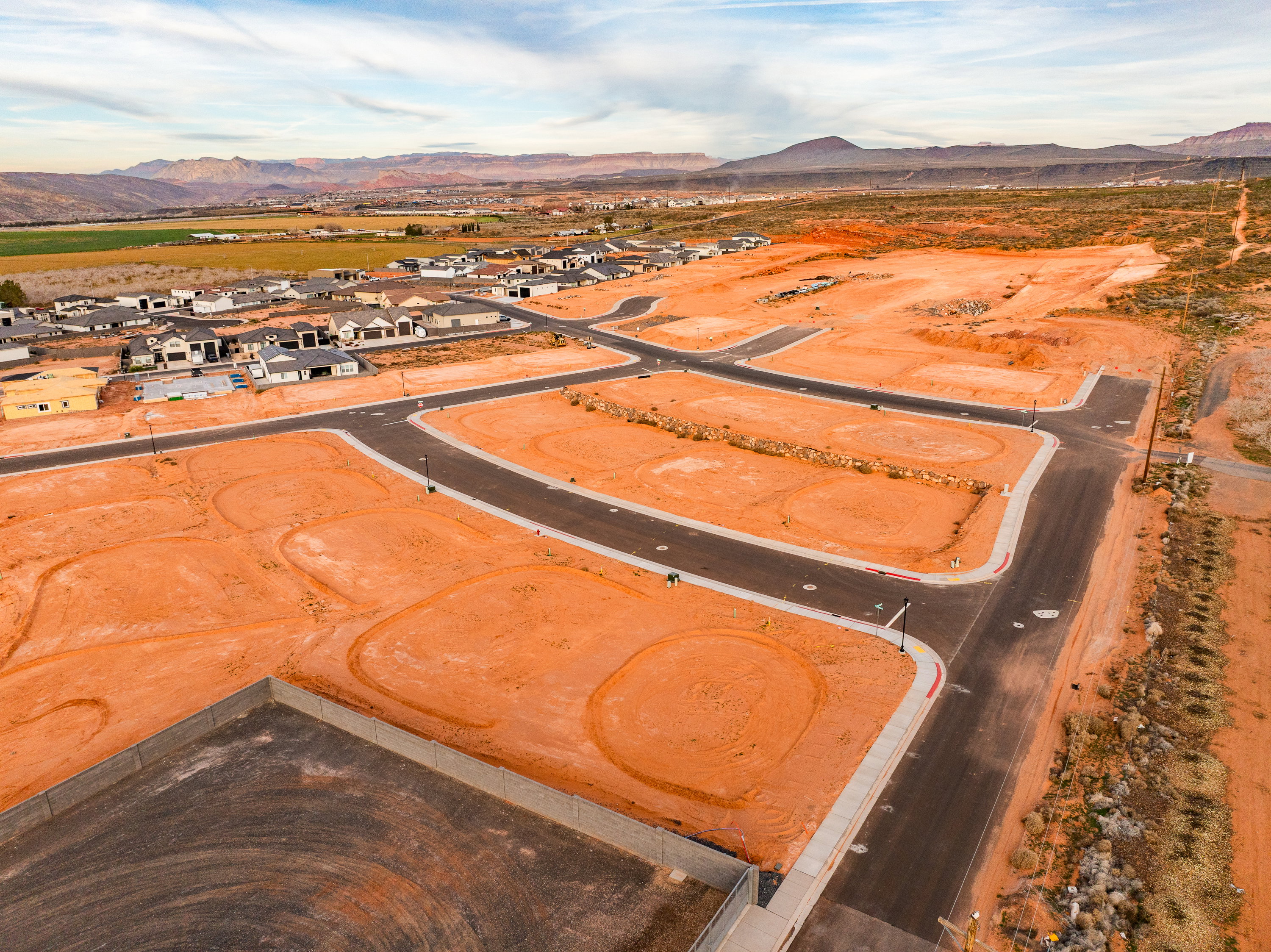 Aerial perspective of suburban area with a mountain backdrop and a desert landscape